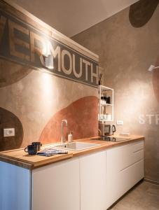 a kitchen with a sink and a sign on the wall at Loft B in Turin