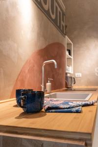 a kitchen counter with a cup and a sink at Loft B in Turin