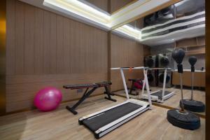 a room with a gym with a treadmill and a pink ball at From K Huan Kai Hotel -Changsha Wuyi Plaza IFS Branch in Changsha