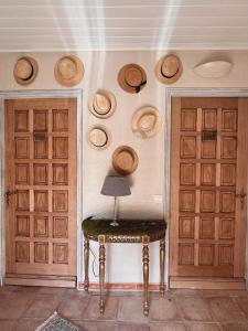 a room with two doors and a table with a lamp at La demeure des poètes chambres d'hôtes in Les Cabannes