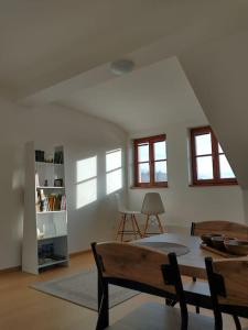 a living room with a table and chairs and windows at Apartment Felicitas in Kašperské Hory