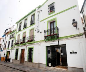 a white building with a sign on the side of it at Vitium Córdoba in Córdoba