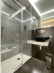 a bathroom with a shower with a glass door at Casa Granatelli in Palermo +37 photos