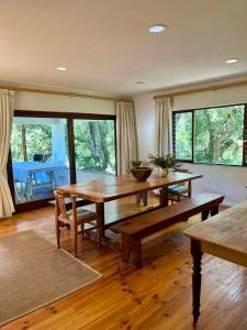 a living room with a wooden table and benches at Lagoon View in Plettenberg Bay