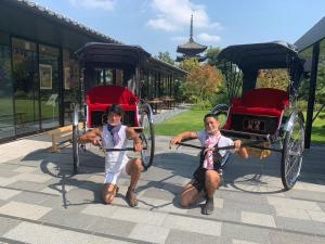 two young children pulling a horse drawn carriage at The Hotel Seiryu Kyoto Kiyomizu in Kyoto