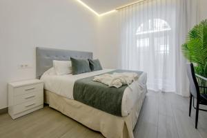 Łóżko lub łóżka w pokoju w obiekcie SUARA Apartamentos 2