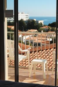 a balcony with white chairs and a view of the ocean at Can Salvador in Miami Platja