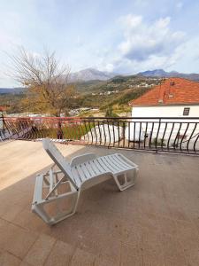 a white bench sitting on top of a roof at Apartman Krivokapic in Igalo