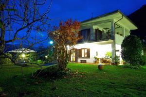a house in a yard at night at LAKE ORTA OPENSPACE garden beach in Pettenasco +21 photos