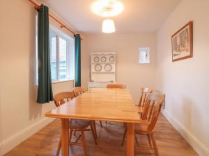 a dining room with a wooden table and chairs at Cheriton in Tuxford