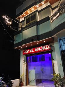 a hotel entrance with a neon sign on it at HOTEL ANJALI in Ujjain