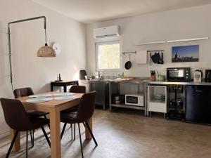 a kitchen with a table and chairs in a room at Gästehaus Sille in Morsbach - Holpe in Morsbach