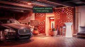 a car parked in front of a building with lights at Hotel Capital with private wellness in Nitra