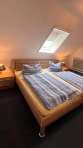 een slaapkamer met 2 bedden en een dakraam bij Buschhof Albers in Neuharlingersiel