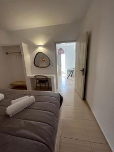 a room with a couch and a table and a door at BlackRock suites in Karterados