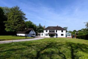 a large white house on a grassy field at The Coach House at Wenvoe Manor, Cardiff in Wenvoe