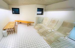 a room with three chairs and a table and a bench at Michels Apartment in Titisee-Neustadt