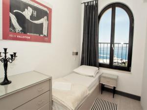 a bedroom with a bed and a window with a view at Apartments & Room Vesna in Brela