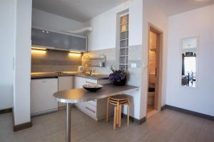 a kitchen with a wooden table and a sink at Apartments & Room Vesna in Brela