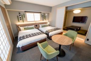 a hotel room with two beds and a table and chairs at RESI STAY Hotel SUN CHLORELLA in Kyoto +34 photos