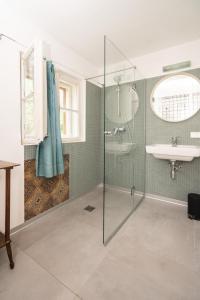 a bathroom with a glass shower and a sink at Gut Hornegg in Preding