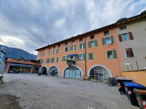 a large orange building with a lot of windows at Casa Vacanze S.Tomaso in Riva del Garda