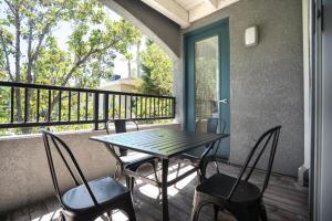 a porch with a table and chairs on a balcony at Sunnyvale 1BR w Pool WD Gym nr 101 SFO-1049 in Sunnyvale