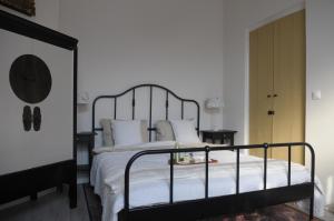 a bedroom with a large bed with white sheets and pillows at De Parel van Pekel in Nieuwe Pekela