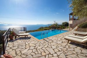 a swimming pool with a view of the ocean at The Lookout, boutique villa. in Sivota