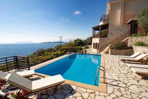 a house with a swimming pool next to the ocean at The Lookout, boutique villa. in Sivota