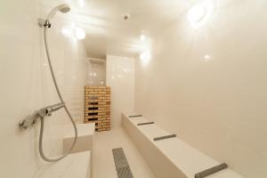 a bathroom with a shower with a bench and a shower at Sakura Terrace The Gallery in Kyoto