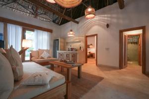 a living room with a couch and a table at Villa Tulia in Matemwe