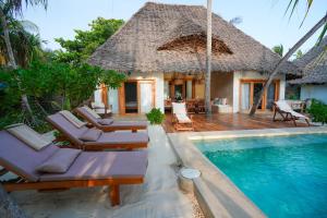 a villa with a swimming pool and a resort at Villa Tulia in Matemwe