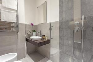 a bathroom with a toilet and a sink and a shower at St. George's Vatican Suites in Rome