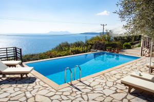 a swimming pool with a view of the ocean at The Lookout, boutique villa. in Sivota