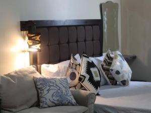 a bedroom with a bed with pillows on it at Avida Tower 2 Mountain View Condominium in Davao City