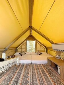 a yellow tent with two beds in a room at 柴口岸 Chaikuo Waterfront in Green Island