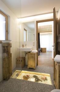 a bathroom with a sink and a mirror at Appartement Pichler in Dobbiaco