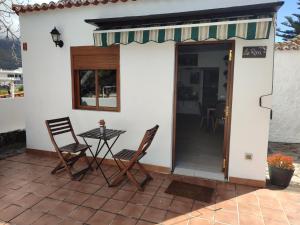 a patio with two chairs and a table on a house at Hacienda FELIX in El Paso