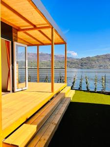 a wooden deck with a view of the water at Lago Maggiore Bay in Baveno