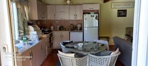 a kitchen with a table and a white refrigerator at Farm House in Kusadasi in Aydın