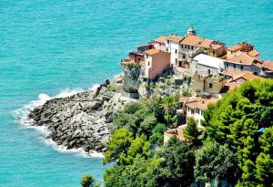 a small town on a rocky island in the ocean at Gambero Nero in Tellaro