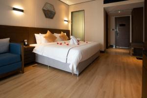 Rúm í herbergi á Huanyu Jun Hui Hotel