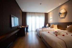Rúm í herbergi á Huanyu Jun Hui Hotel
