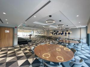 a conference room with tables and chairs and a stage at Holiday Inn Express - Ankara - Airport by IHG in Ankara
