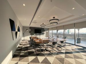 a dining room with a table and chairs and windows at Holiday Inn Express - Ankara - Airport by IHG in Ankara