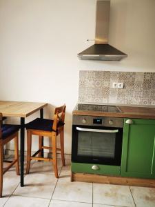 a kitchen with a green stove and a table at Tesy in Sveti Filip i Jakov