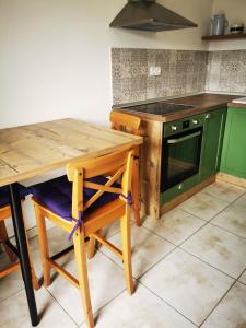 a kitchen with a wooden table and a stove at Tesy in Sveti Filip i Jakov