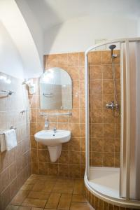 a bathroom with a sink and a shower at Hostel Little Quarter in Prague