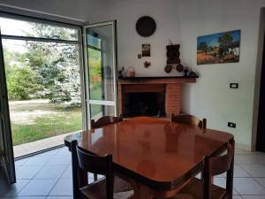 a dining room with a table and a fireplace at Casetta in Collina in Sezze